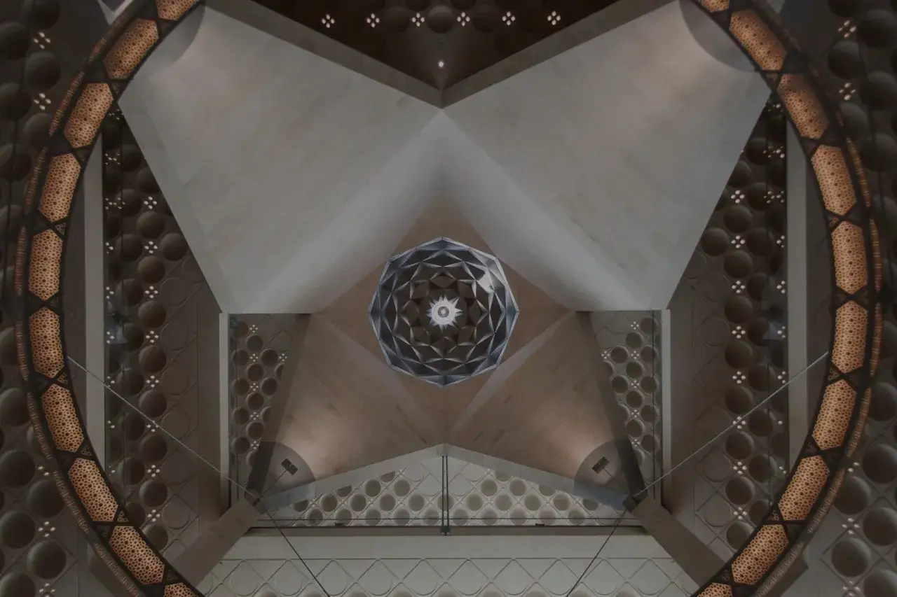 Wnętrze muzeum sztuki islamskiej z geometryczną kopułą i ozdobnymi łukami.